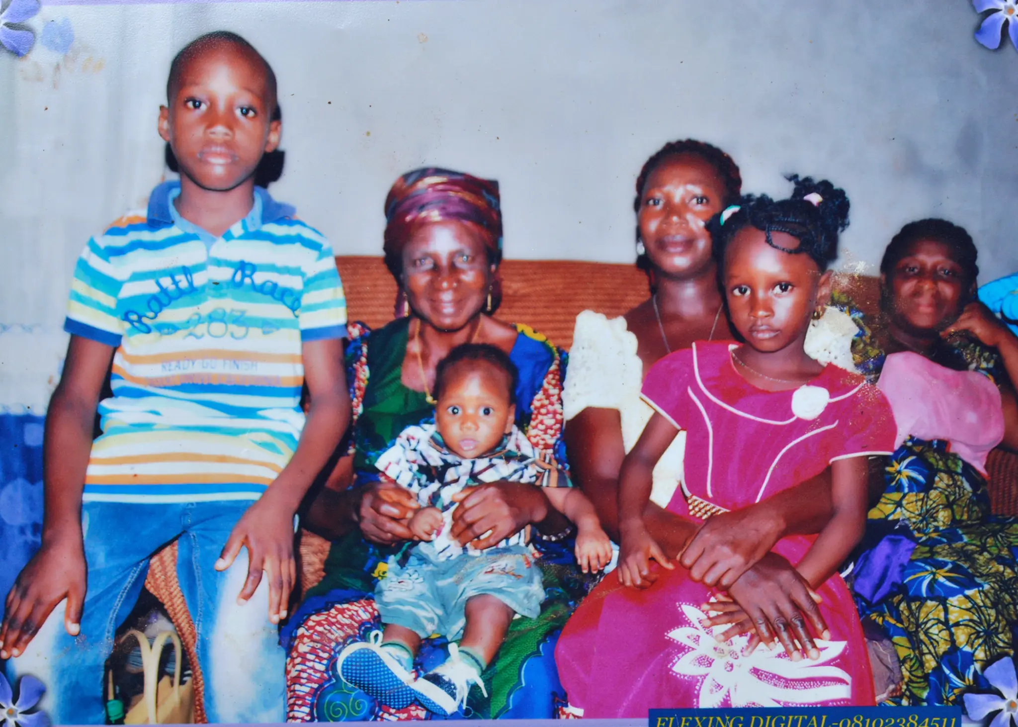 Josephine seated with children and grandchildren in a multigenerational family photograph